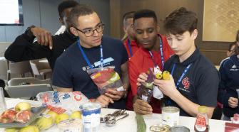 Three boys looking at food